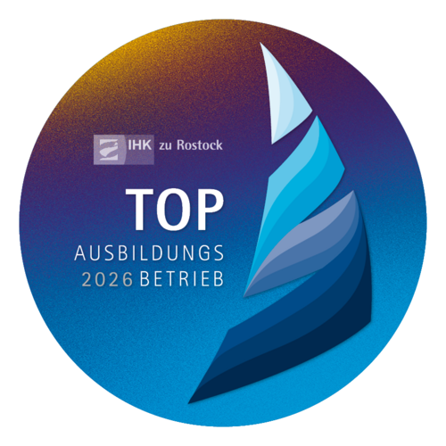 Rundes Logo mit Text "Top Ausbilungsbetrieb 2026"